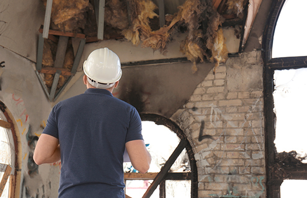 Insurance adjuster inspecting fire damage